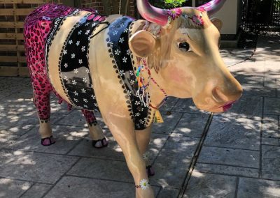 Full-sized fiberglass cow restored to original pink colors